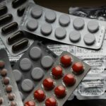 Close-up of various pills in blister packs showcasing medical and healthcare themes.